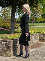 Sexy secretary Milf Jenny takes her lunch break outdoors wearing her nice suit, sunglasses, sexy nylons and tall shiny black stilettos